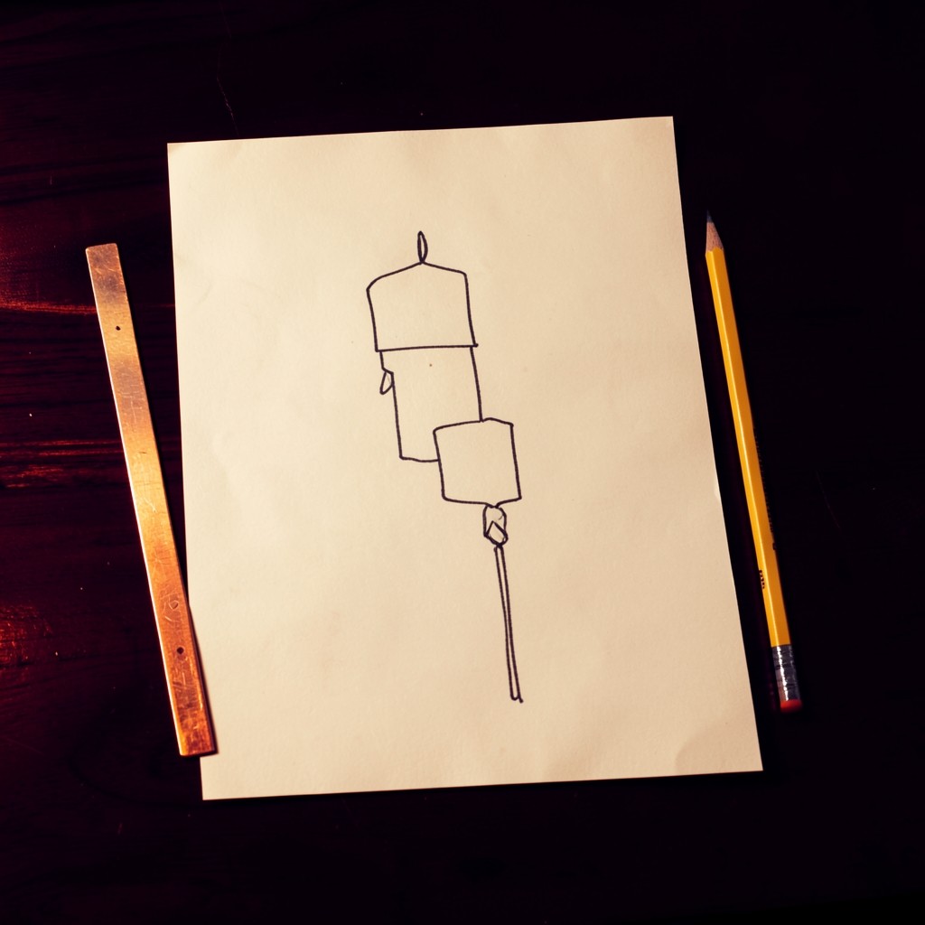 Overhead view of ivory paper with hand-drawn candlesticks highlighting an engulfing pair and a pin bar